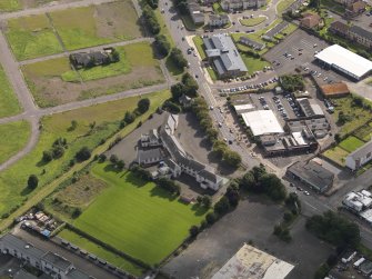 Oblique aerial view centred on St Francis' RC primary school, taken from the NW.