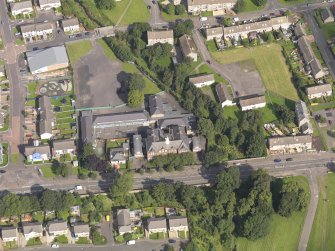 Oblique aerial view centred on Niddrie Marischal primary school, taken from the S.