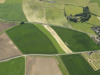 General oblique aerial view centred on the field boundaries with the cemetery adjacent, taken from the NNE.