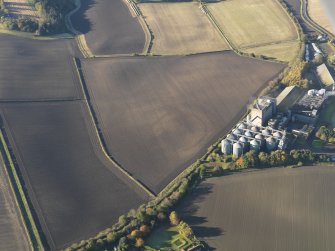 Oblique aerial view of the soilmarks of the fort with the Pentcaitland maltings adjacent, taken from the E.