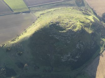 Oblique aerial view of the remains of the fort and settlement on North Berwick Law, taken from the NE.