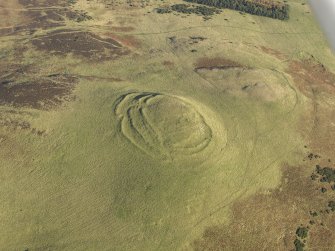Oblique aerial view of the remains of the fort, cairn and rig at Cockburn Law, taken from the SW.