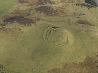 Oblique aerial view of the remains of the fort, cairn and rig at Cockburn Law, taken from the WSW.