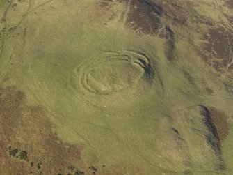 Oblique aerial view of the remains of the fort, cairn and rig at Cockburn Law, taken from the SSE.