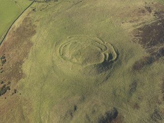 Oblique aerial view of the remains of the fort, cairn and rig at Cockburn Law, taken from the ESE.