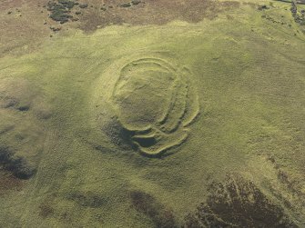 Oblique aerial view of the remains of the fort, cairn and rig at Cockburn Law, taken from the NE.