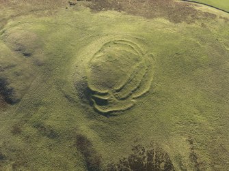 Oblique aerial view of the remains of the fort, cairn and rig at Cockburn Law, taken from the NNE.