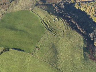 Oblique aerial view of the remains of the fort, settlement and broch at Edin's Hall and the adjacent settlement, taken from the S.