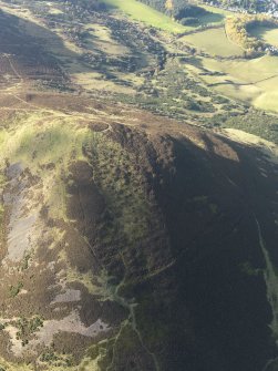 Oblique aerial view of the remains of the fort on Eildon Hill North, taken from the ENE.