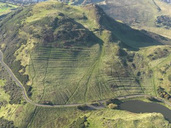 Oblique aerial view of the cultivation terraces and the remains of the fort on Arthur's Seat, taken from the E.
