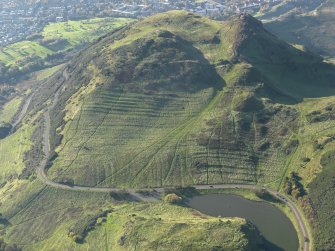 Oblique aerial view of the cultivation terraces and the remains of the fort on Arthur's Seat, taken from the ENE.