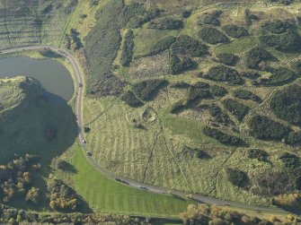 Oblique aerial view of the remains of the quarry and rig and furrow, taken from the ENE.