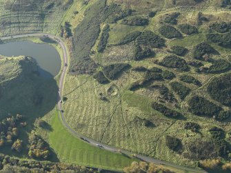 Oblique aerial view of the remains of the quarry and rig and furrow, taken from the ENE.