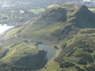 Oblique aerial view of the cultivation terraces and the remains of the fort on Arthur's Seat, taken from the NE.