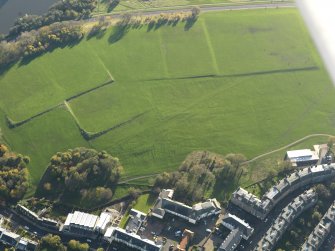 Oblique aerial view of the slight earthworks on the site of Clockmill House, Holyrood Park, taken from the N.