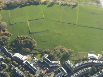Oblique aerial view of the slight earthworks on the site of Clockmill House, Holyrood Park, taken from the N.
