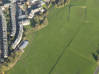Oblique aerial view of the slight earthworks on the site of Clockmill House, Holyrood Park, taken from the SW.