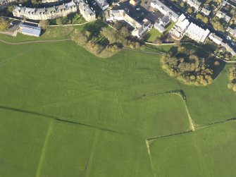 Oblique aerial view of the slight earthworks on the site of Clockmill House, Holyrood Park, taken from the SSW.