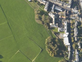Oblique aerial view of the slight earthworks on the site of Clockmill House, Holyrood Park, taken from the SE.