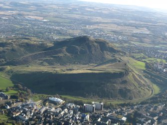 General oblique aerial view looking across Salisbury Crags towards Arthur's Seat, taken from the NW.