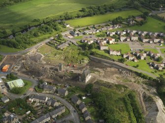 Oblique aerial view centred on the demolition of the distillery, taken from the NNW.