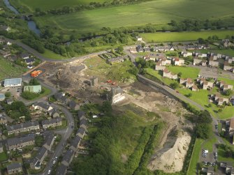 Oblique aerial view centred on the demolition of the distillery, taken from the NW.