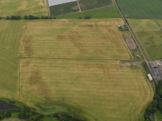 Oblique aerial view centred on the cropmarks of the rig, pits and barrows on Craigmill Farm, taken from the WSW.