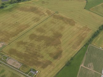 Oblique aerial view centred on the cropmarks of the rig, pits and barrows on Craigmill Farm, taken from the ESE.