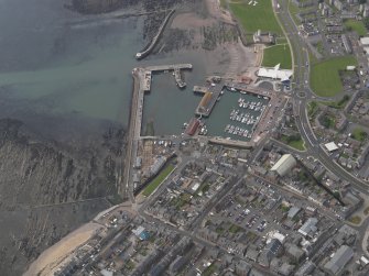 Oblique aerial view of Arbroath centred on the harbour, taken from the NE.