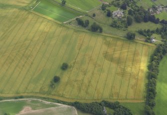 Oblique aerial view of the cropmarks of the buildings and rig and furrow with Lathrisk House adjacent, taken from the NW.