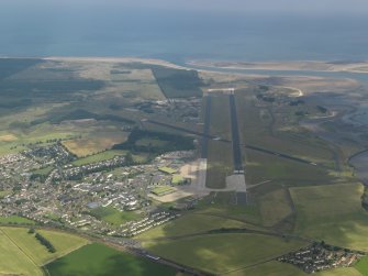 General oblique aerial view of Leuchars village and airfield, taken from the WNW.