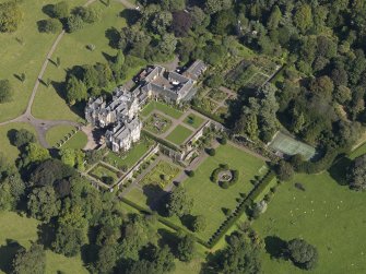 Oblique aerial view centred on the house with the gardens adjacent, taken from the SSW.