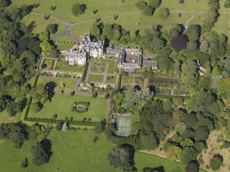 Oblique aerial view centred on the house with the gardens adjacent, taken from the SSE.