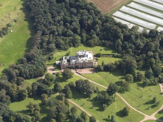 Oblique aerial view centred on the country house , taken from the WSW.
