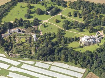 Oblique aerial view centred on the country house with the gardens adjacent , taken from the E.