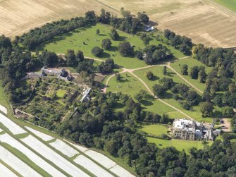 Oblique aerial view centred on the country house with the gardens adjacent , taken from the ENE.