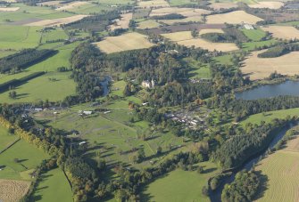 Oblique aerial view centred on the safari park with the country house adjacent, taken from the NE.