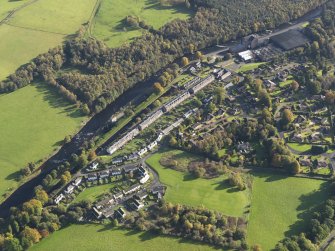 Oblique aerial view centred on the mills with the cottages adjacent, taken from the WNW.