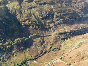 Oblique aerial view centred on the Glen Ogle railway viaduct with the military road adjacent, taken from the ESE.