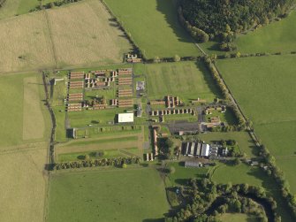 Oblique aerial view centred on the prisoner-of-war and training camps, taken from the WSW.