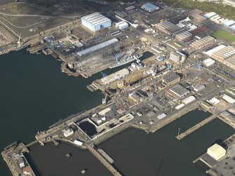 Oblique aerial view centred on the dockyard, taken from the SE.