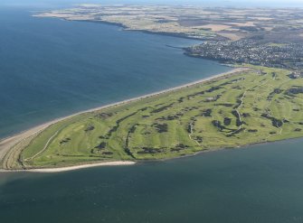 Oblique aerial view over St Andrews showing the links golf courses, taken from the NW.