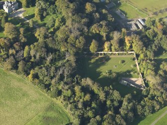 Oblique aerial view centred on the walled garden with the farm and country house adjacent, taken from the SW.
