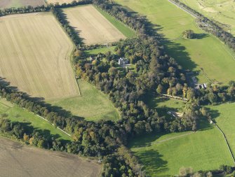 General oblique aerial view centred on the house with the policies adjacent, taken from the SE.