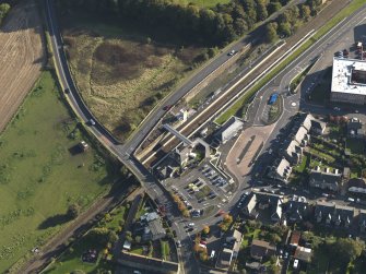 Oblique aerial view centred on the railway station, taken from the NNW.