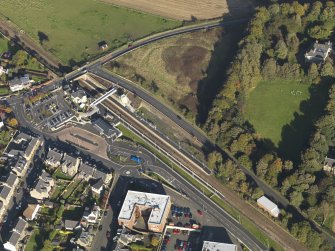 Oblique aerial view centred on the railway station, taken from the SW.