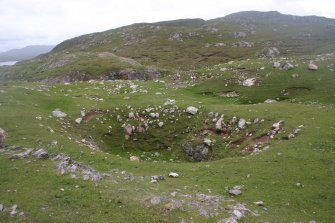 A large bomb crater situated within the E end of the fort (NC37SE 1) on Eilean nan Caorach.