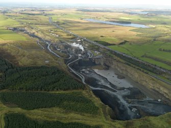 Oblique aerial view centred on the quarry, taken from the E.