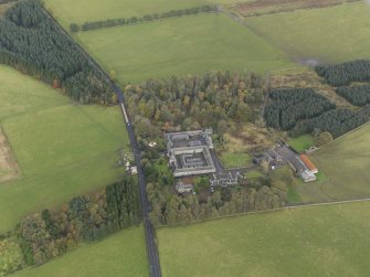 Oblique aerial view centred on the farmstead with the sawmill adjacent, taken from the SW.