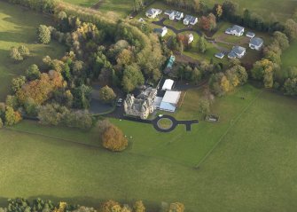 Oblique aerial view centred on the house, taken from the NW.